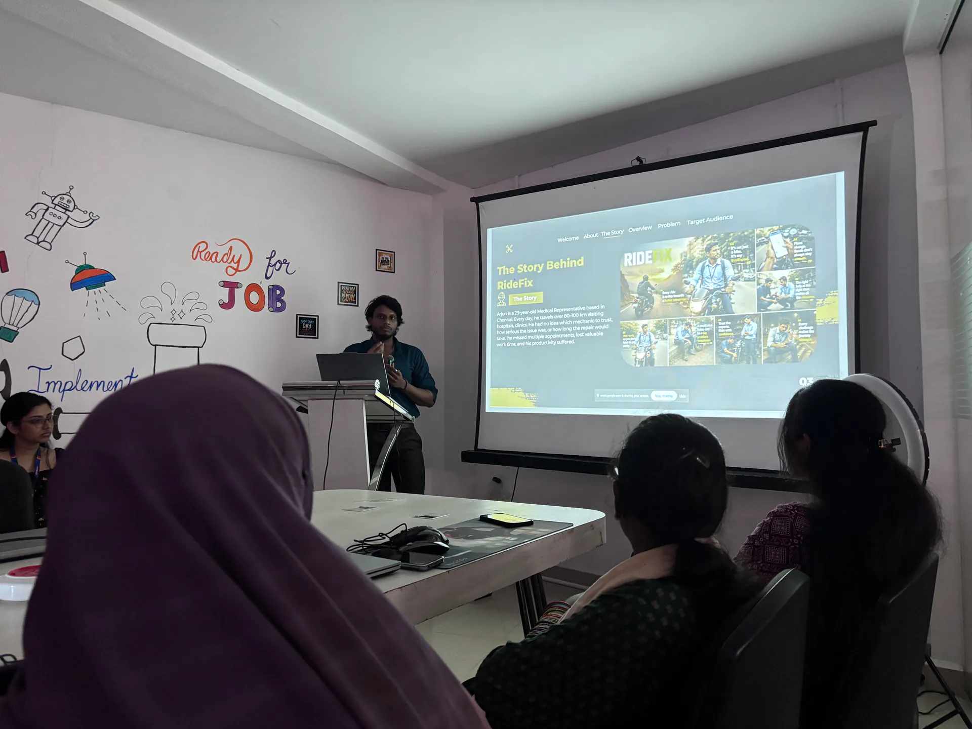 An Ovi Design Academy student presenting a real client-style UX case study to the class